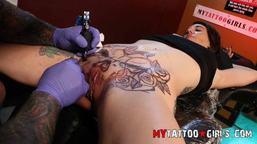 Tattoo master beats a tattoo on a vagina