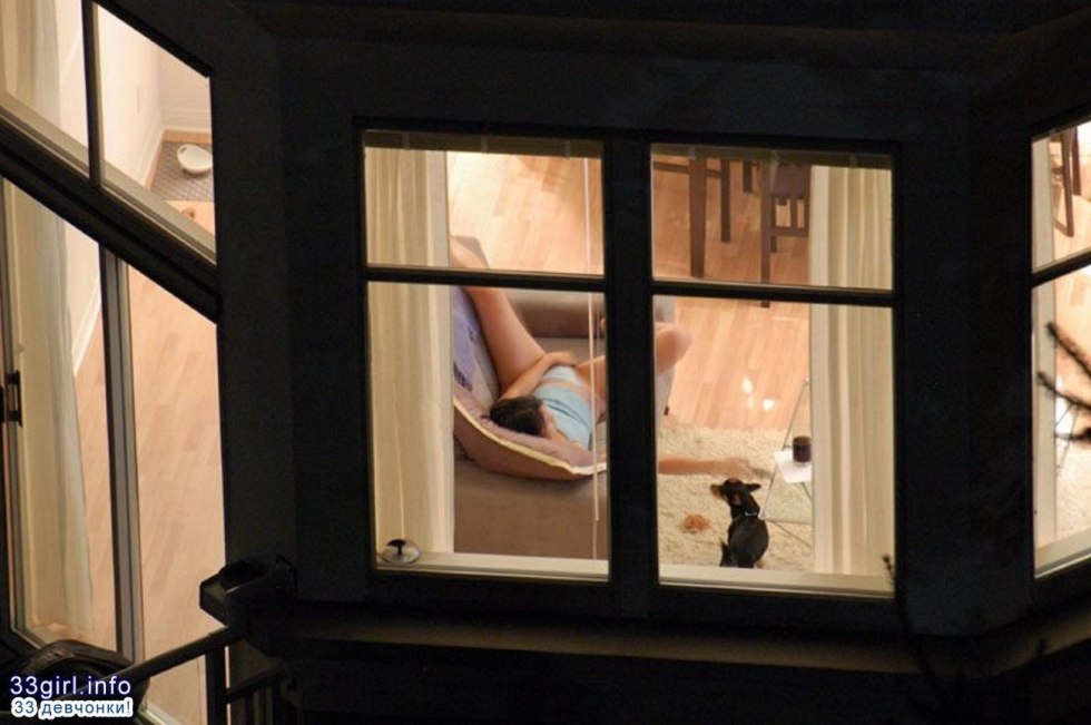 Naked women in the windows of houses