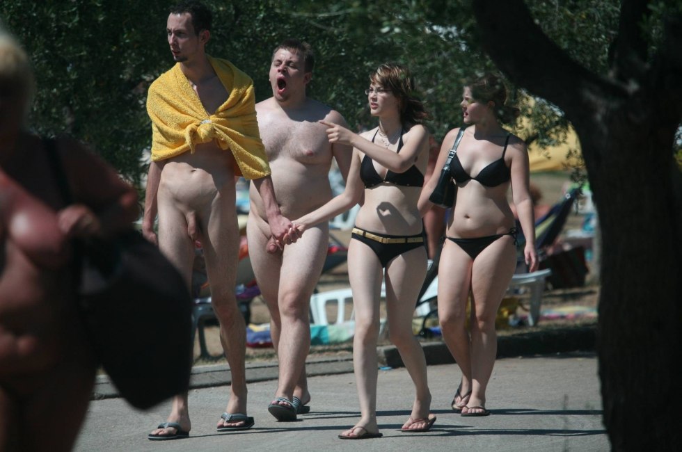 Naked on the beach among dressed