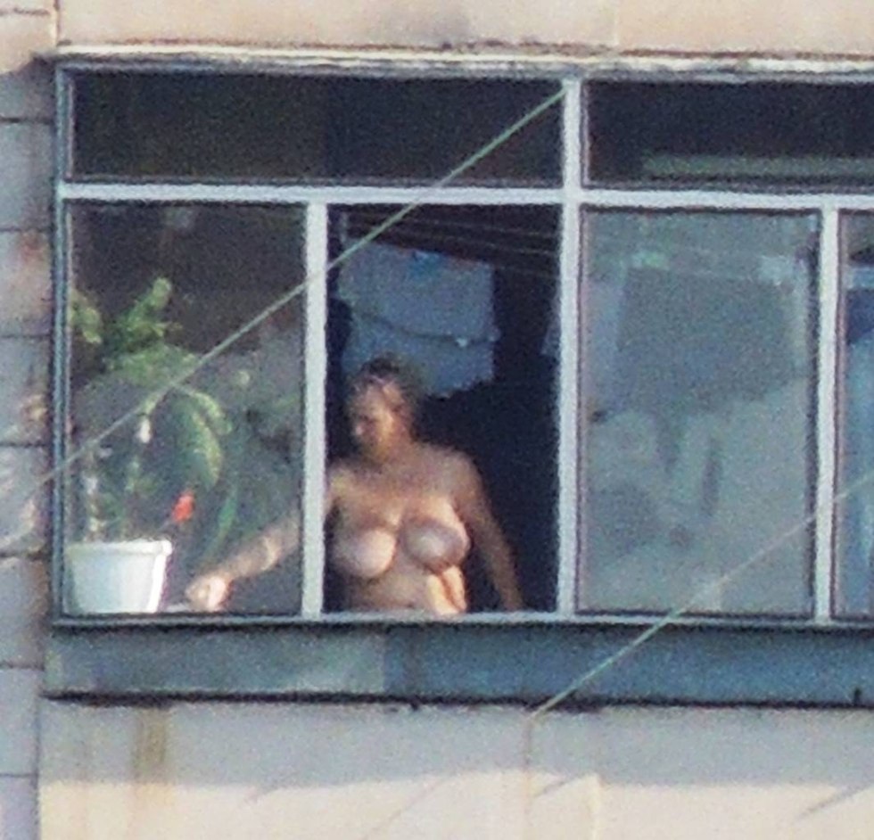 Naked woman in the window opposite
