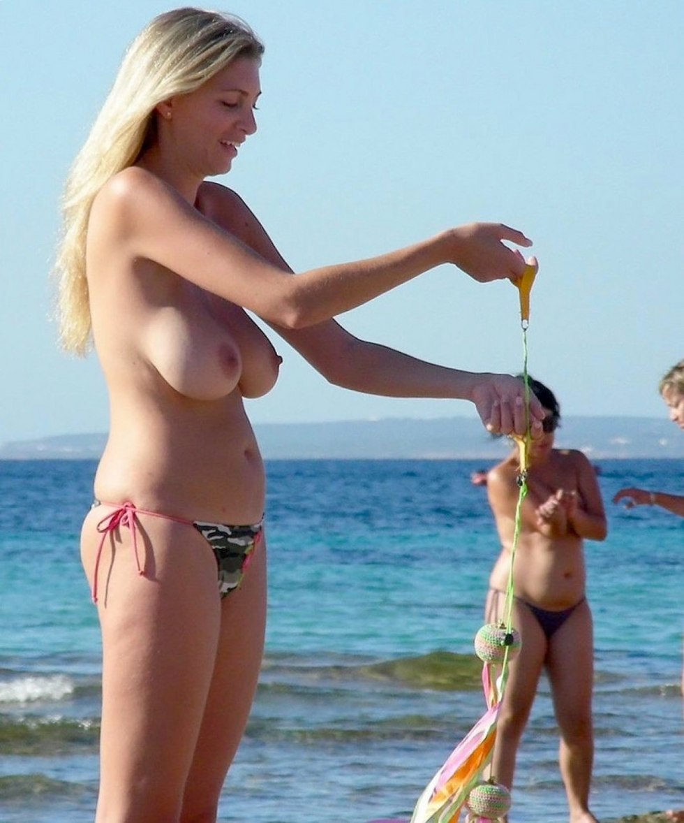 Toples on a public beach with her husband