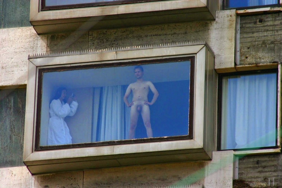 Naked women in the windows of houses