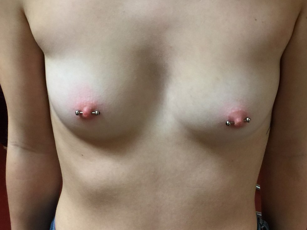 Little female breasts with piercing