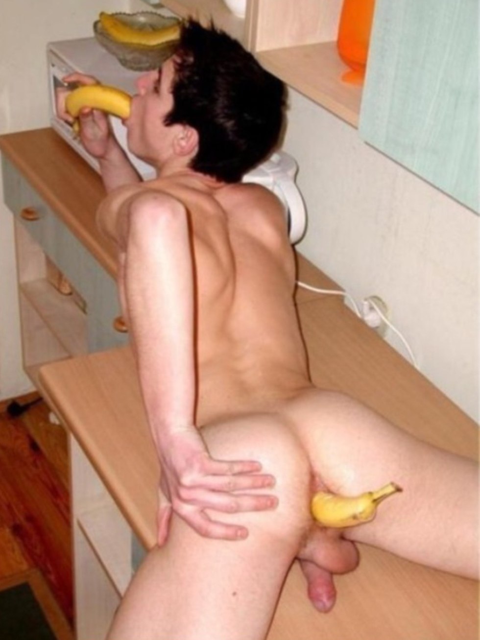 Naked guy with a banana in the ass