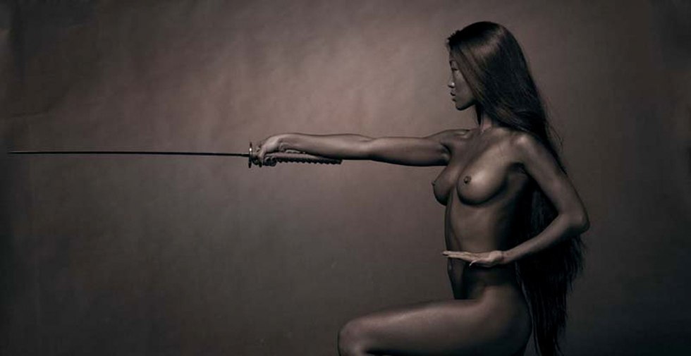 Erotic photo shoot with a sword