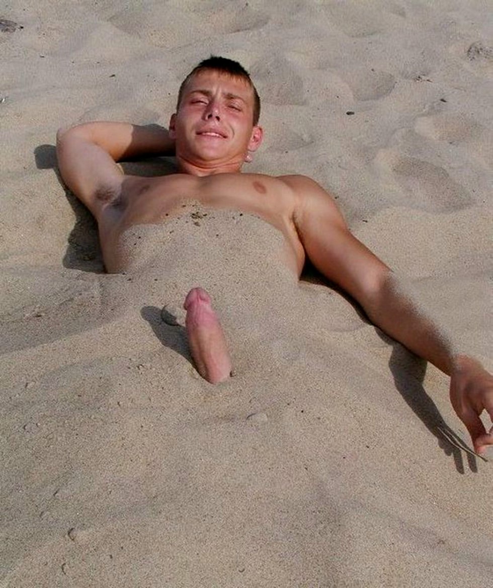Naked guy in the sand on the beach