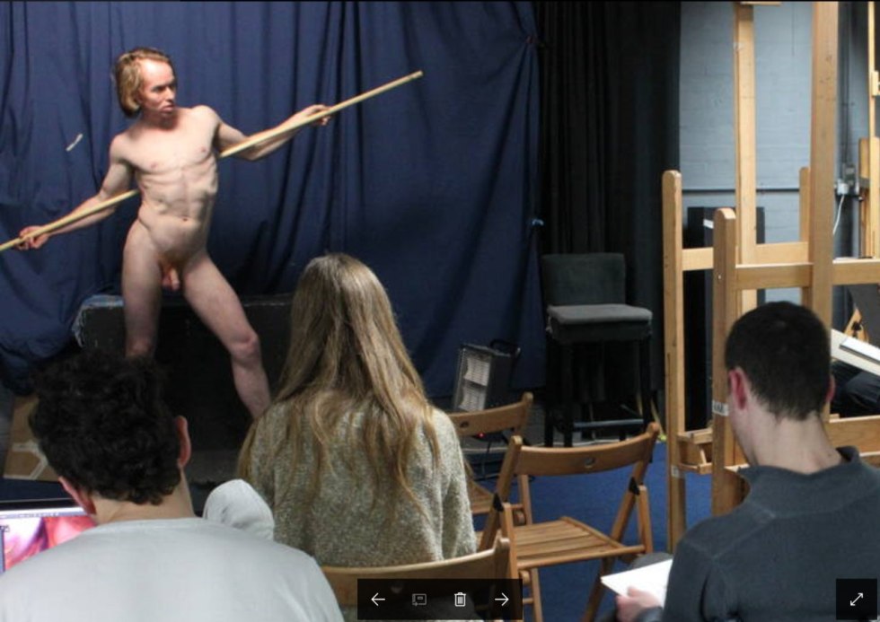 A naked man poses an artist