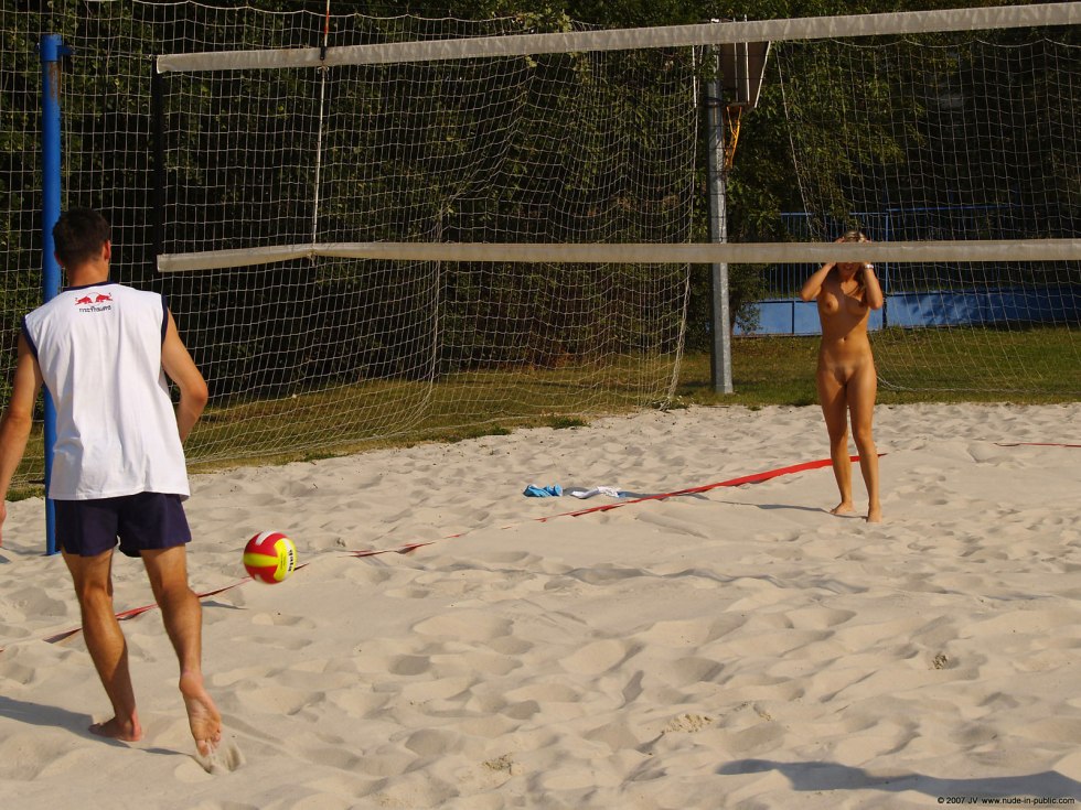 Naked nudists play badminton on the beach