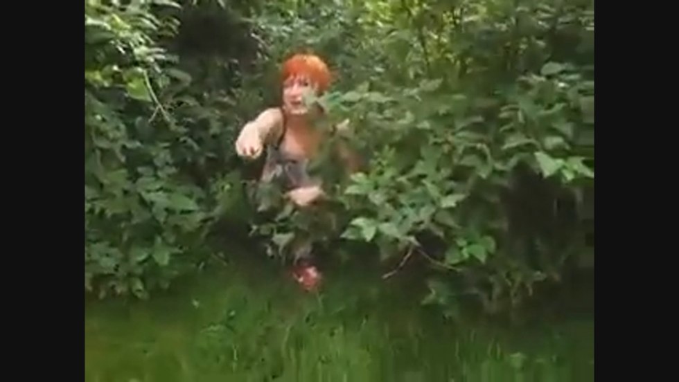 A woman in the bushes