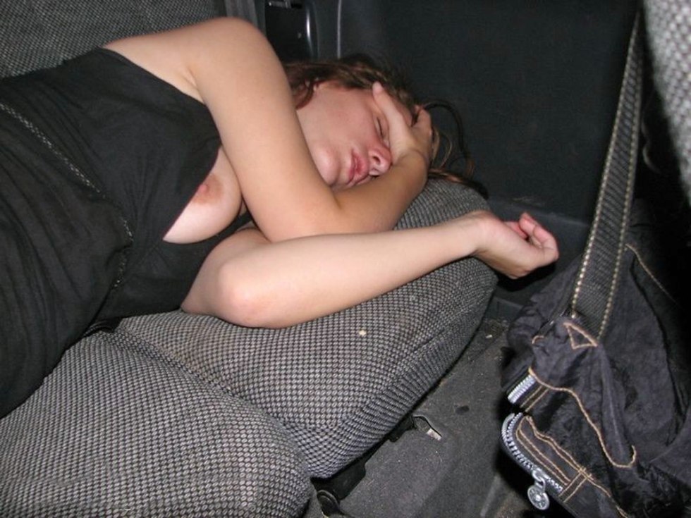 Naked woman sleeps in the car