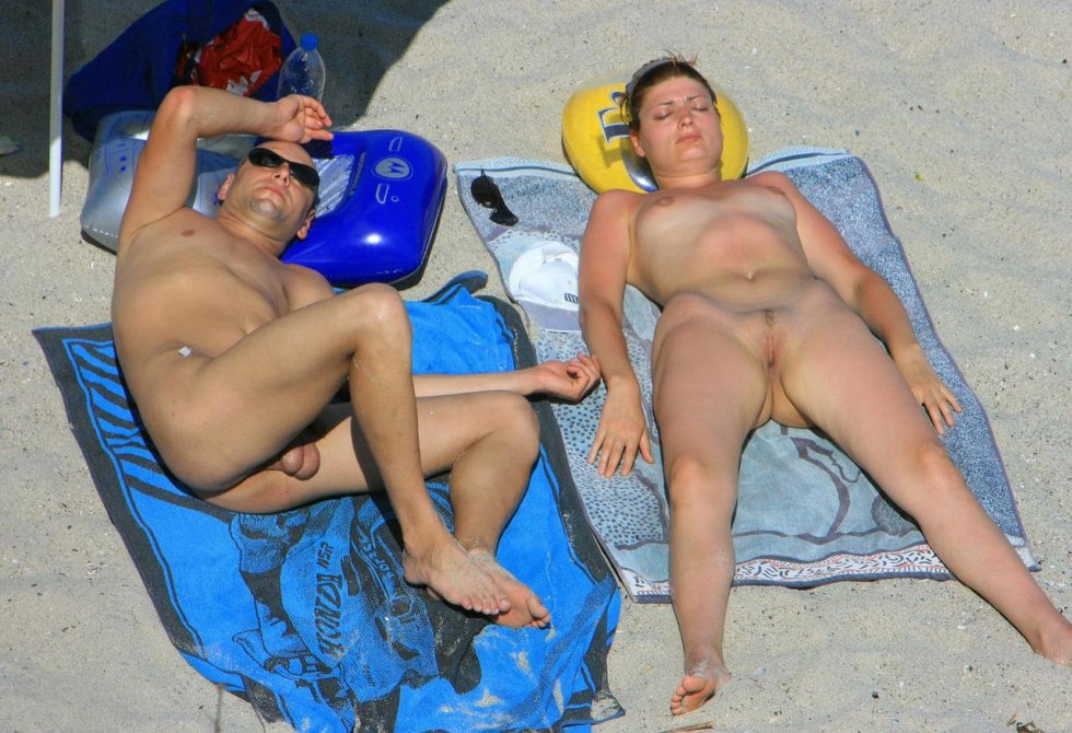 Naked men and women on the beach