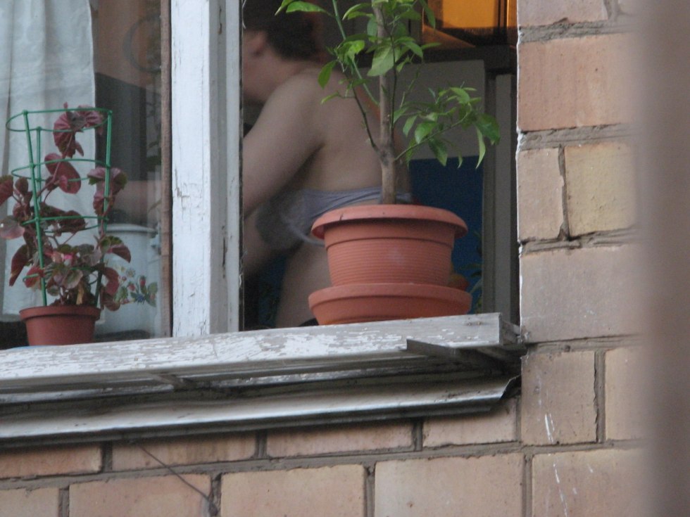 Naked women in the windows of houses