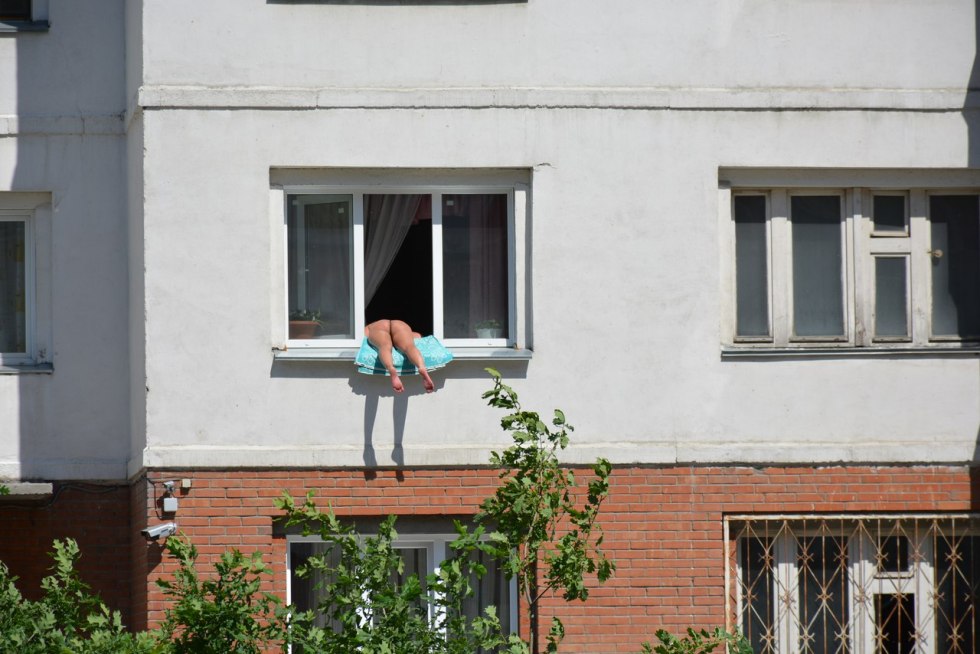 Girl sunbathing in the window