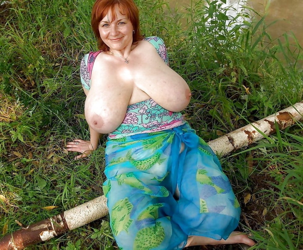 Huge boobs of a woman in the garden