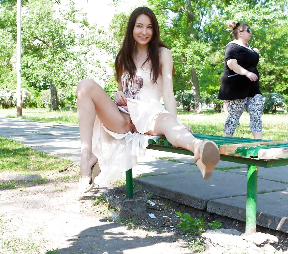 Girl walks in a park without panties