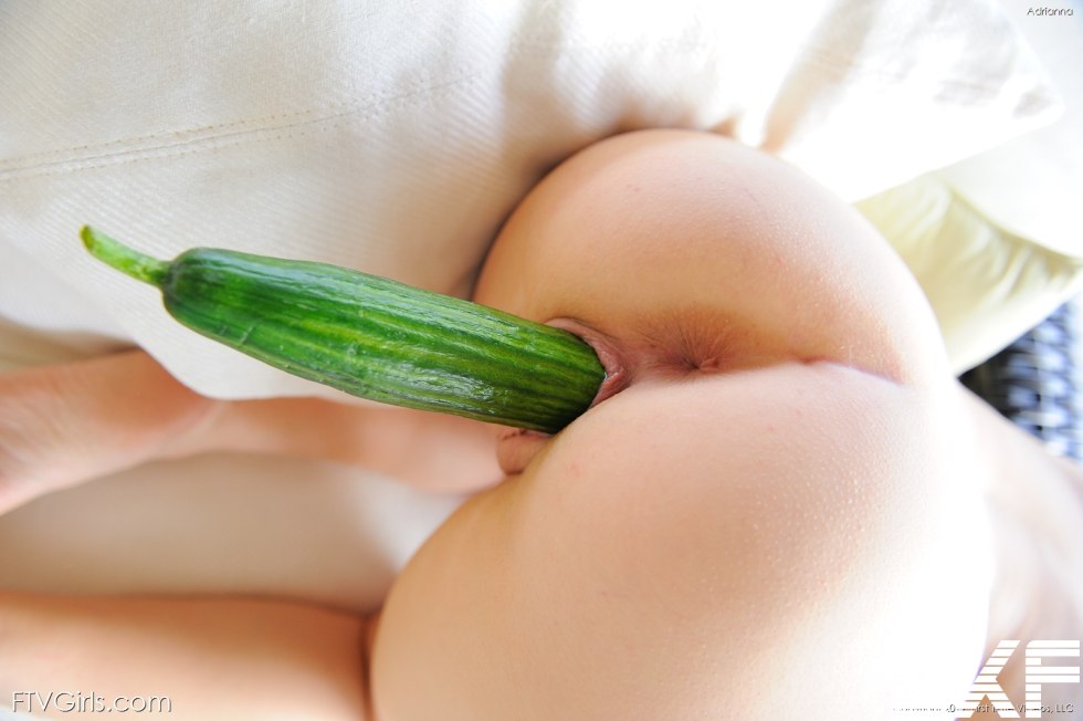 Naked blonde with a cucumber in the ass