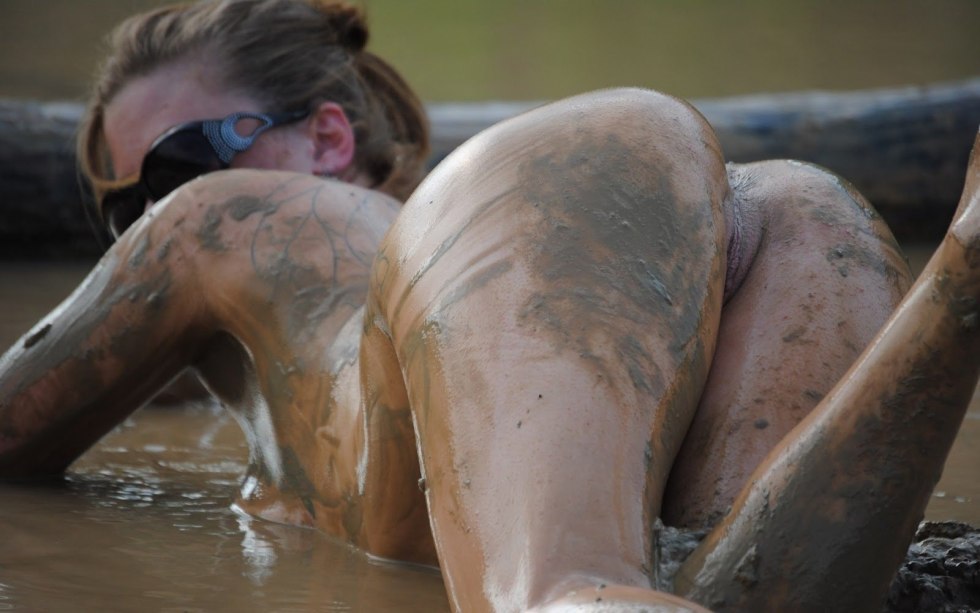 Naked woman in a mud bath
