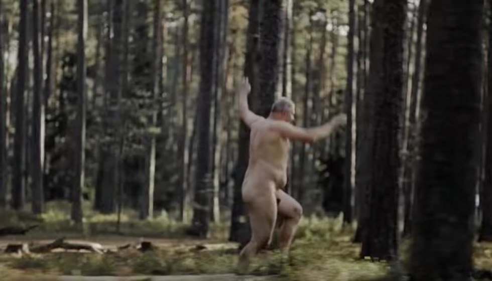 Naked woman runs through the forest