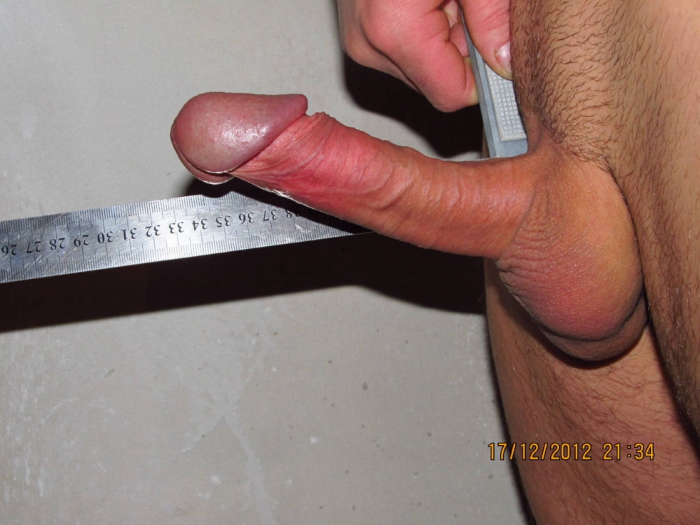 A man's penis with a ruler