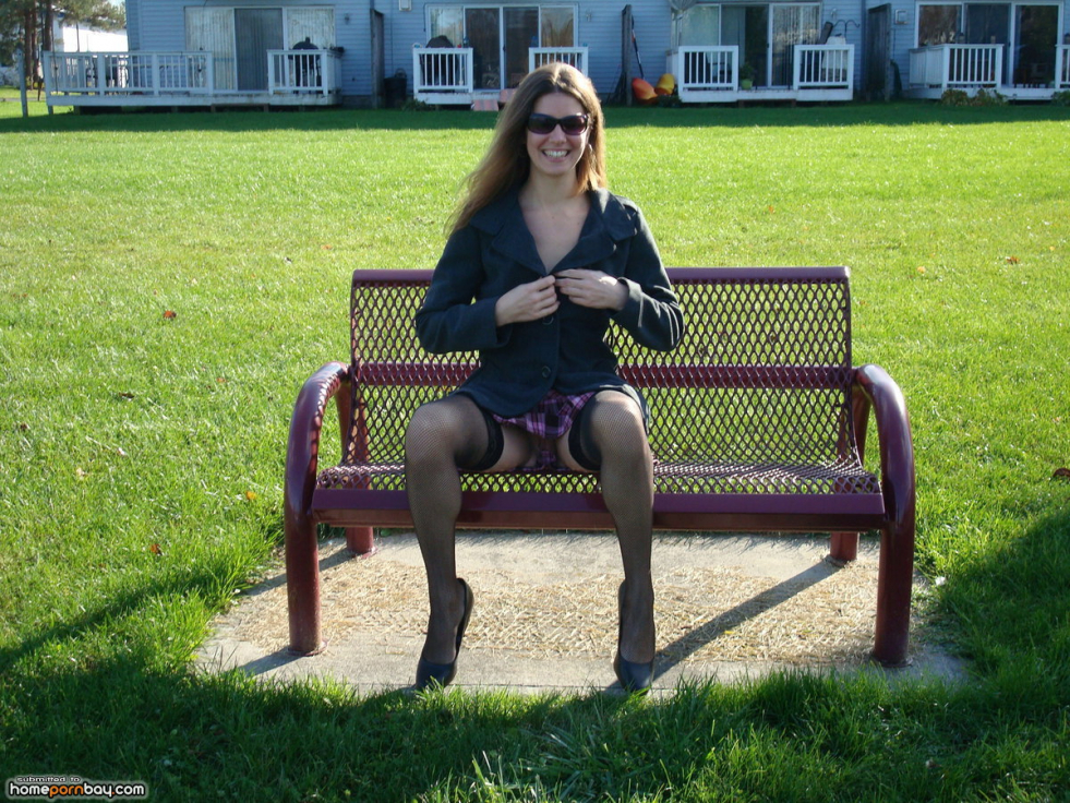 Brunette undresses in the park