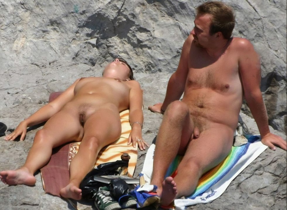 Family couple sunbathes naked
