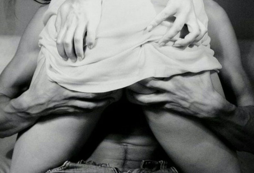 Men's hand between women's legs