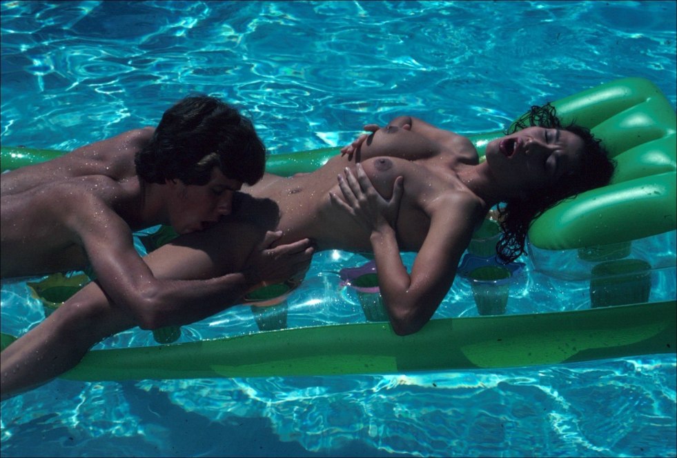 Girl on a mattress in the nude pool