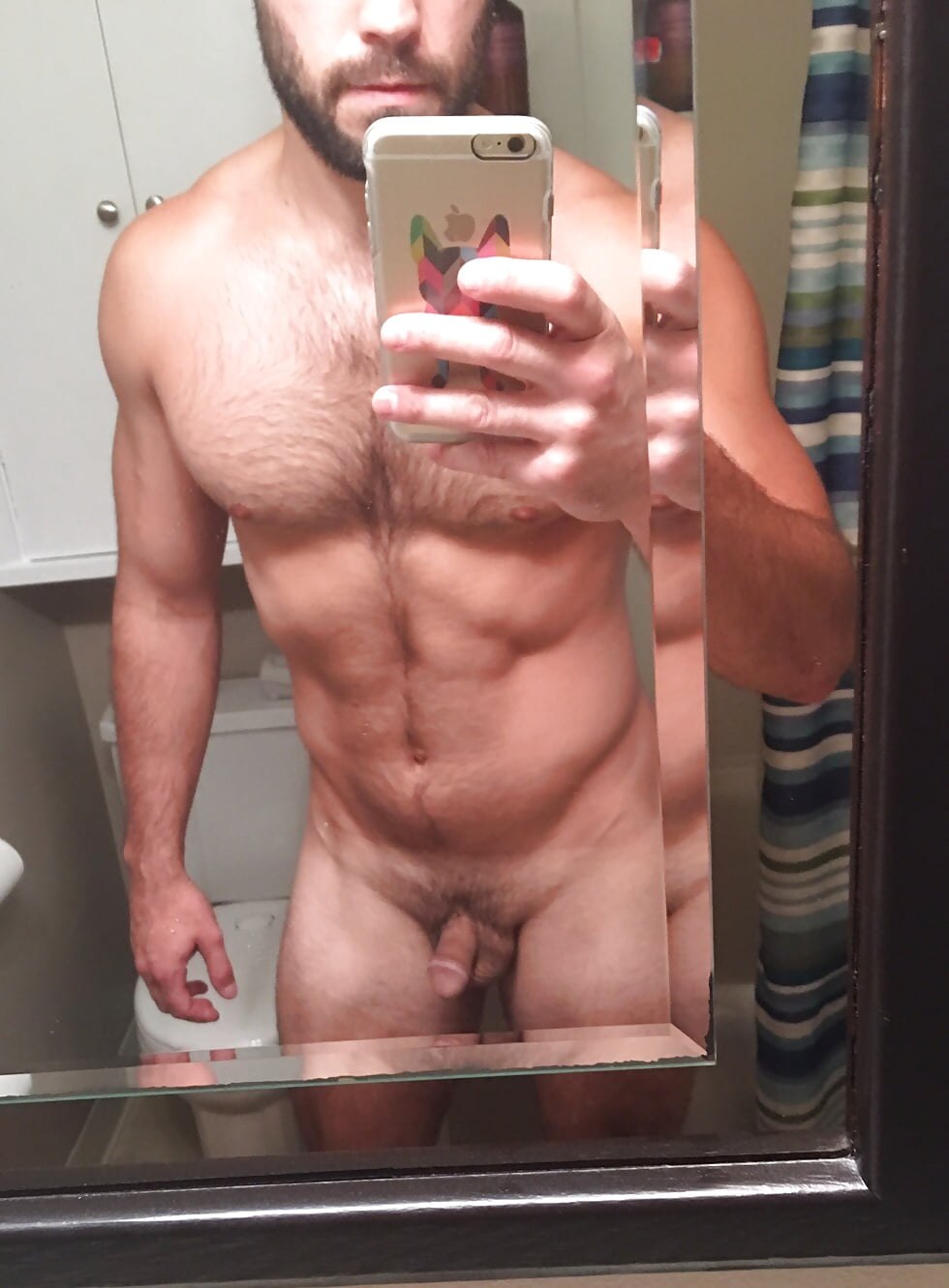 Naked man in front of a mirror