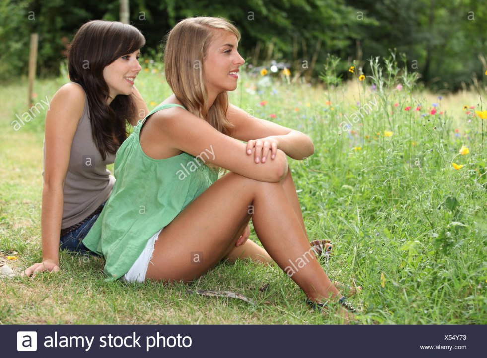Two naked girlfriend in a field