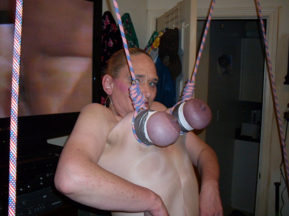 Woman hung up for tits