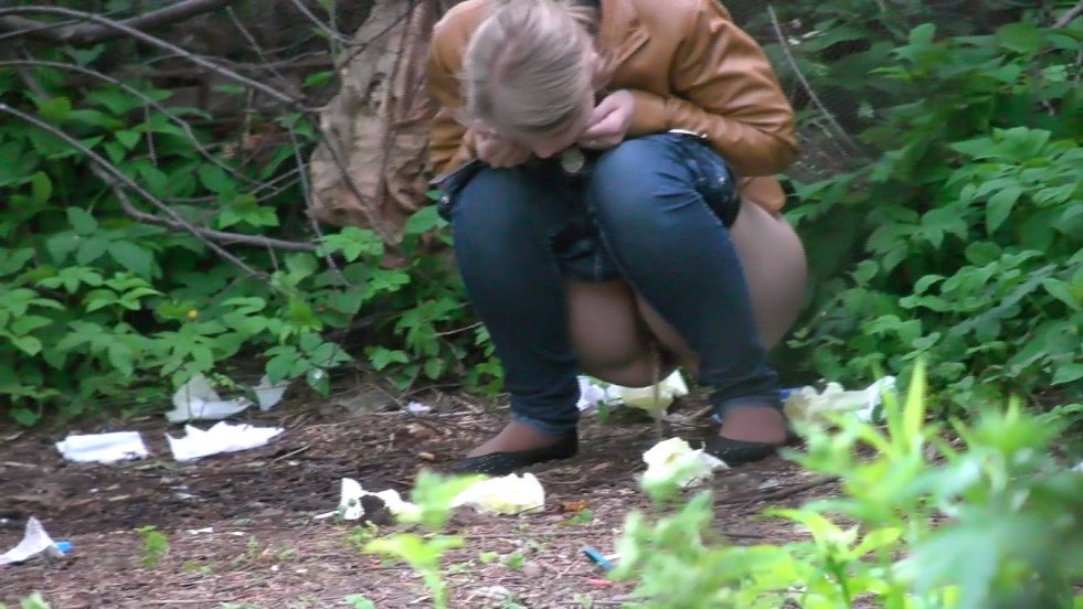 Female pissing in the bushes