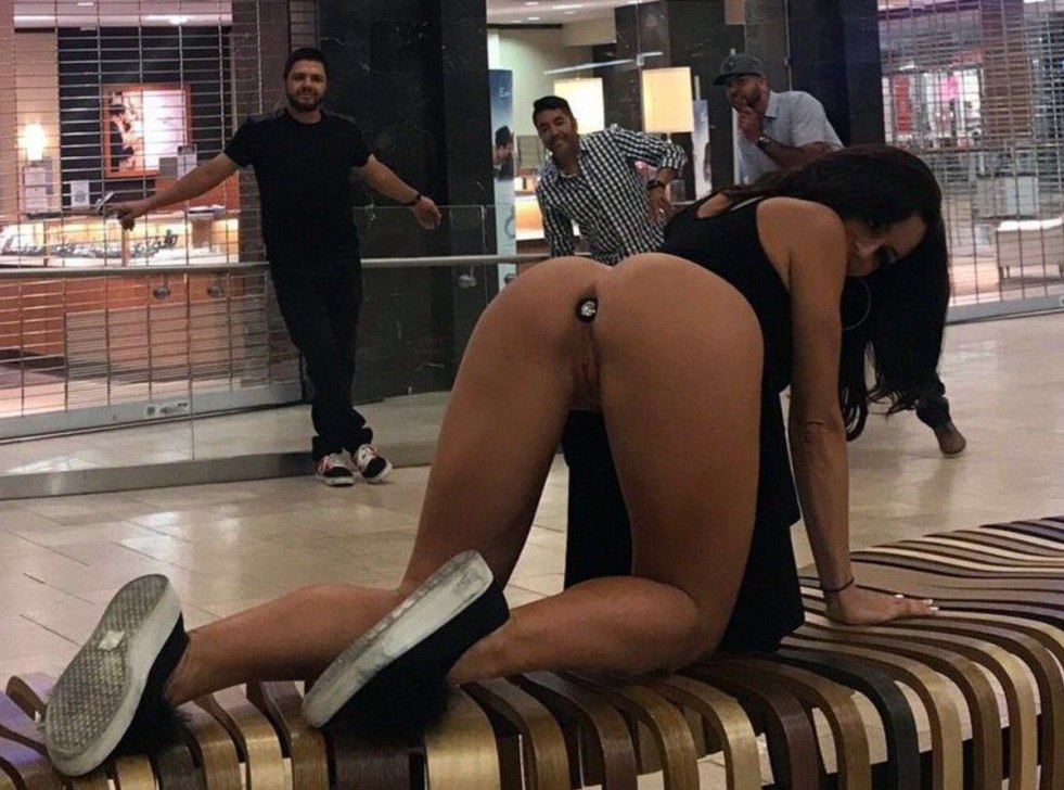 Girl with a butt plug in public