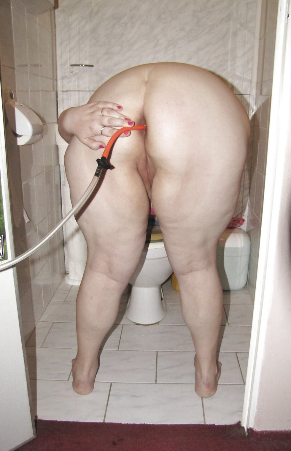 Mature fat woman in the toilet
