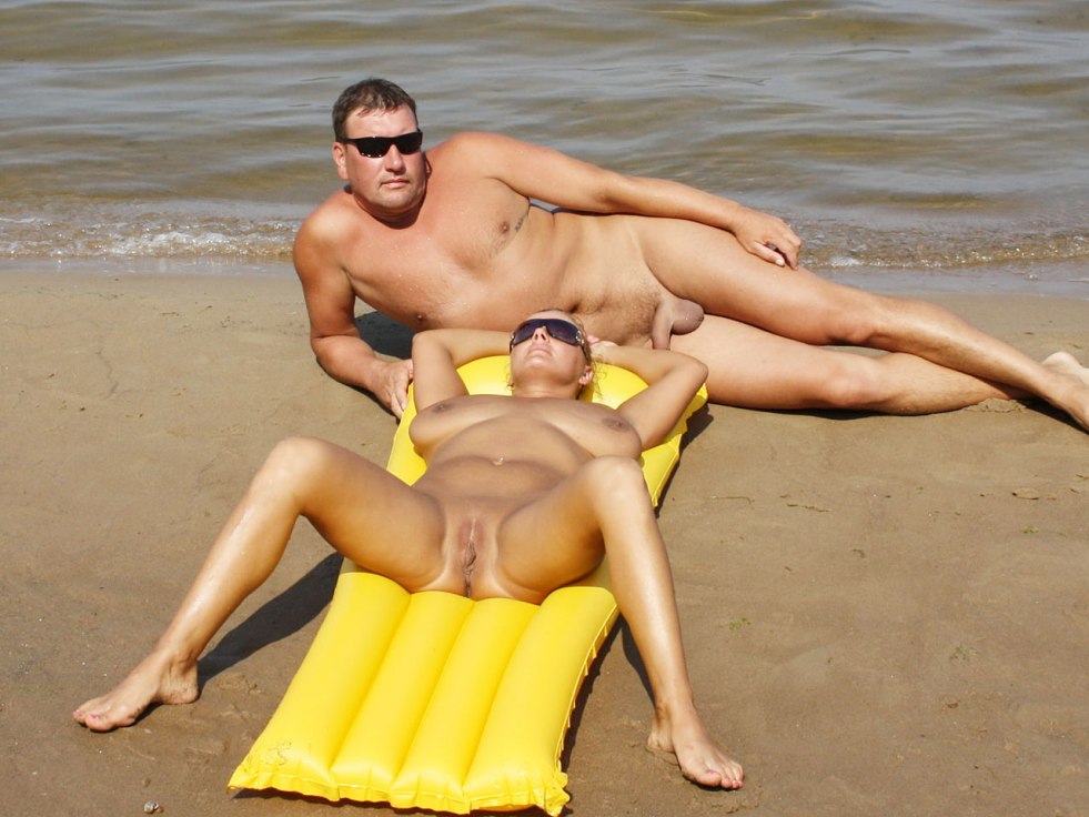 Men and women sunbathe naked