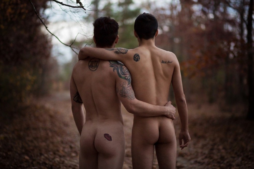 Naked men and women on a wild beach