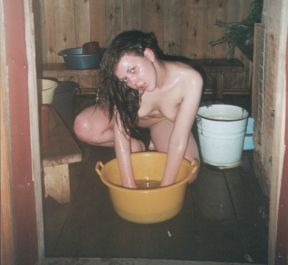 Woman washes in a rustic bath