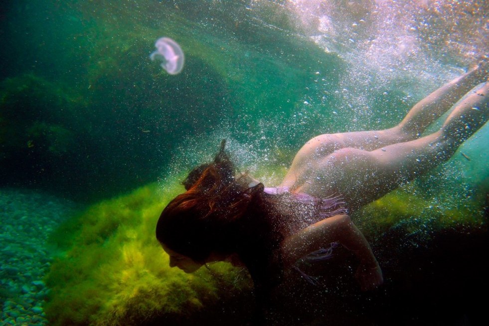 Naked mermaids under water