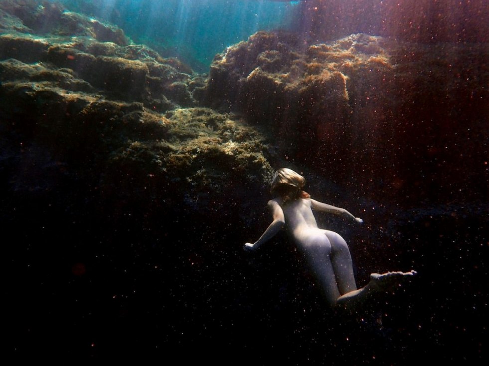 Redhead undressed under water
