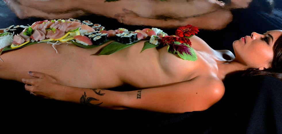 Naked chicks on a table with food