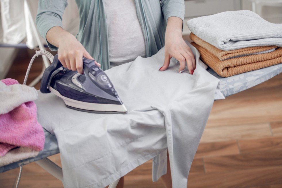 Naked young woman stroking linen