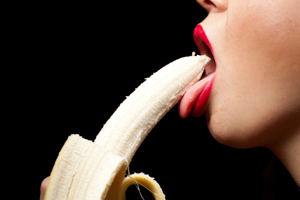 Girl with banana in mouth