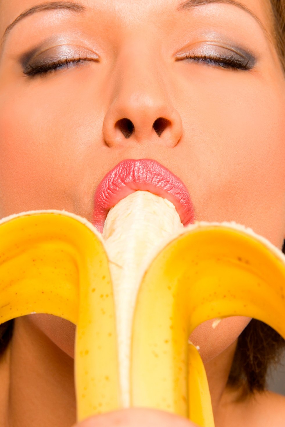 Woman eats banana
