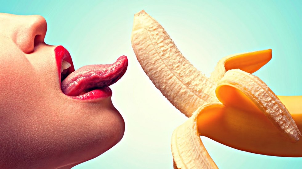 Girl with banana in mouth