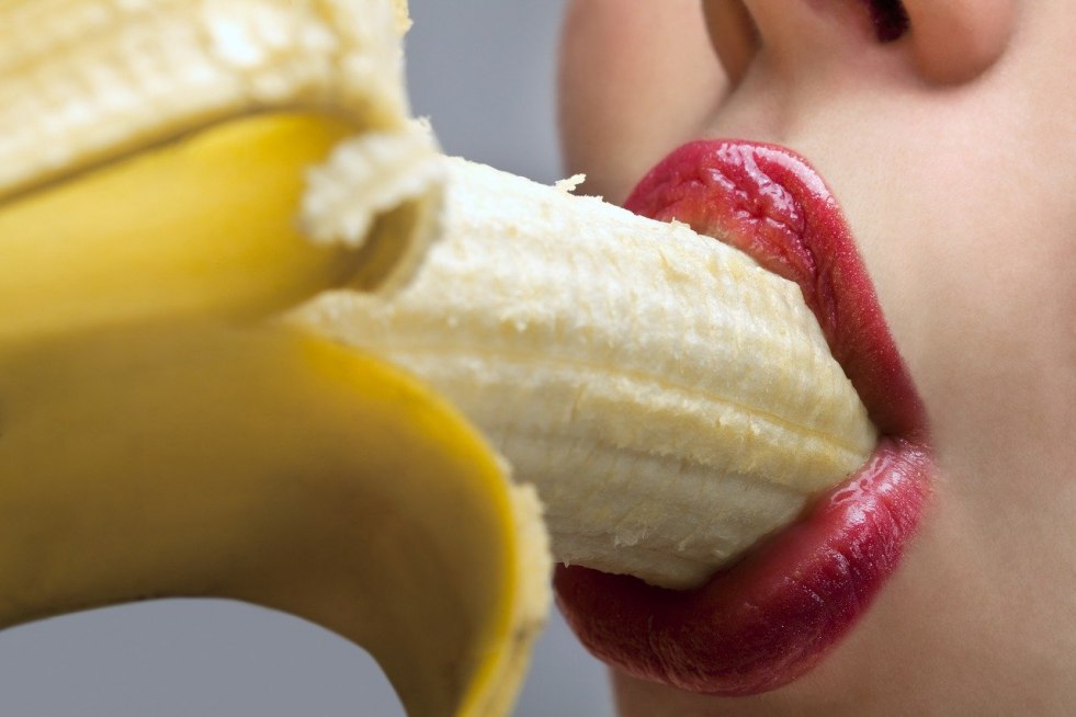 Girl with banana in mouth