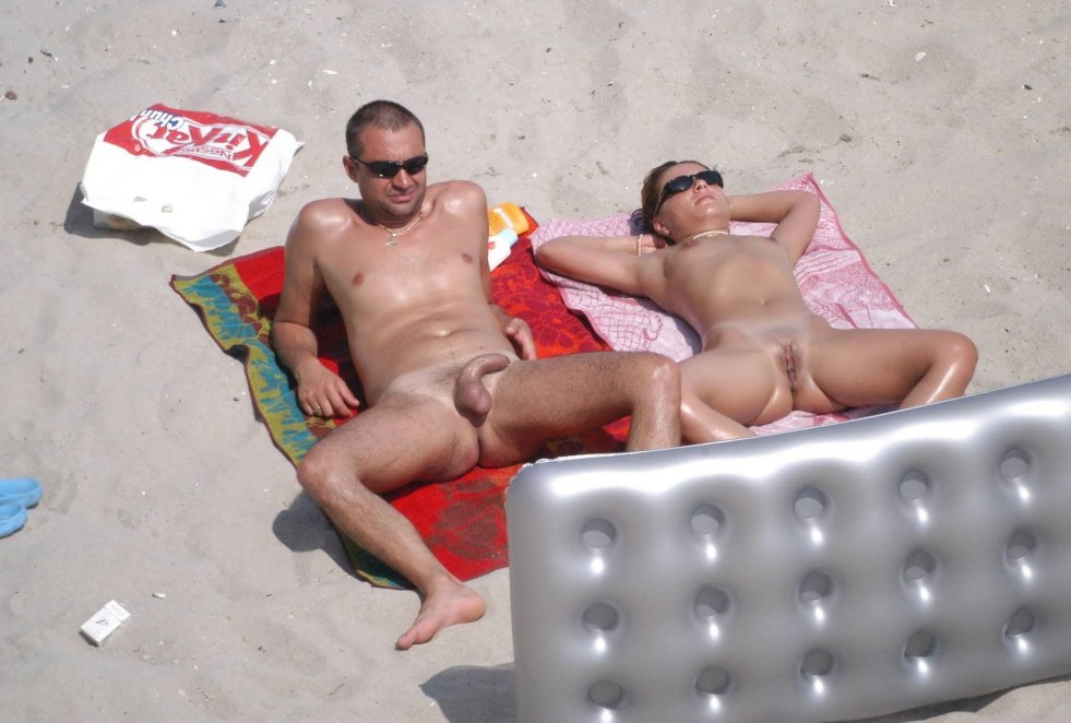 Young couple on a nudist beach