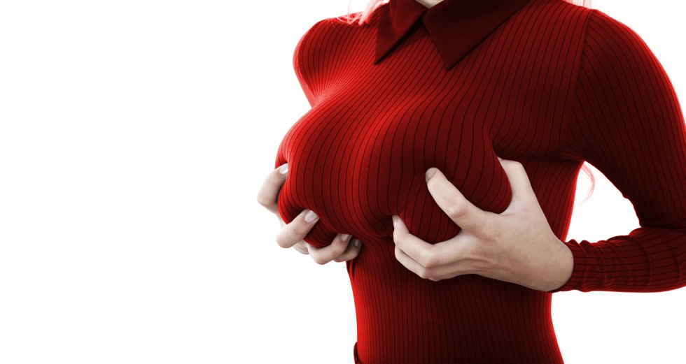 The girl holds her breasts