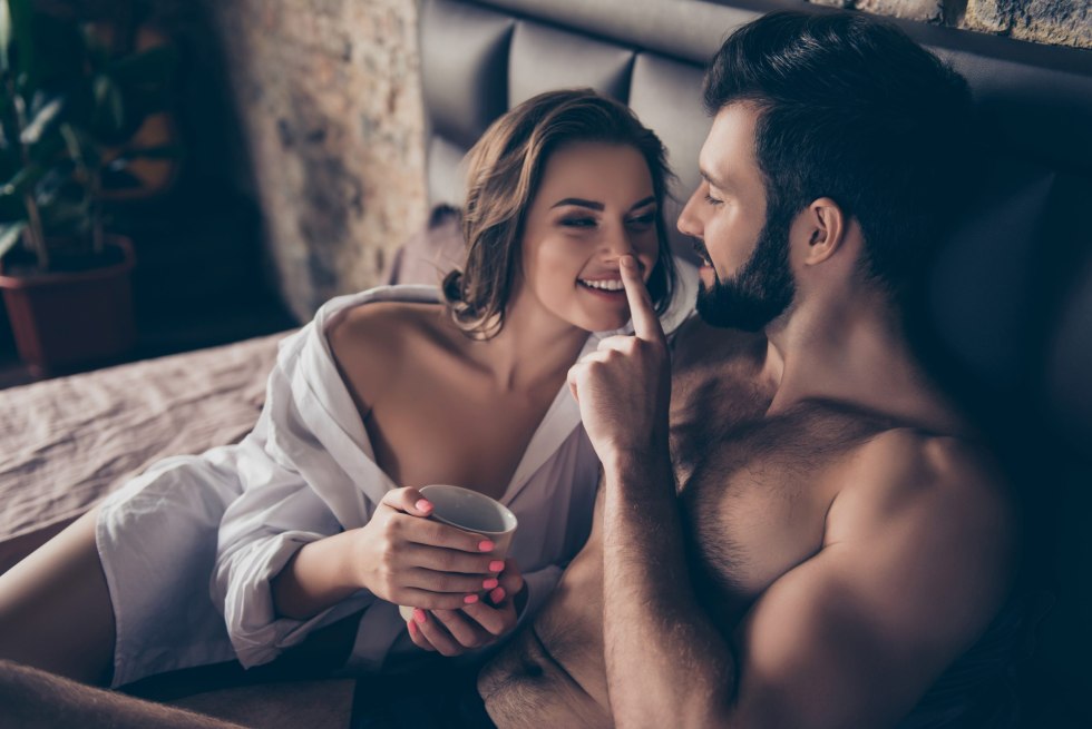 Young couple is chiking in bed