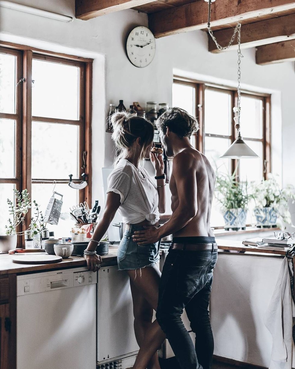 The couple hugs in the kitchen