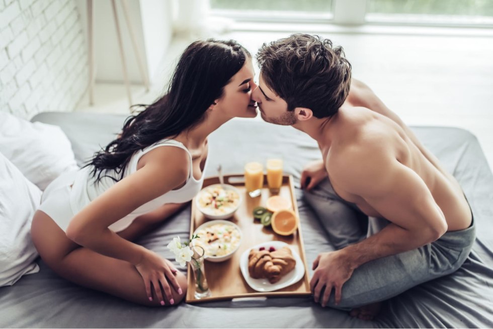 Lovers have breakfast in bed