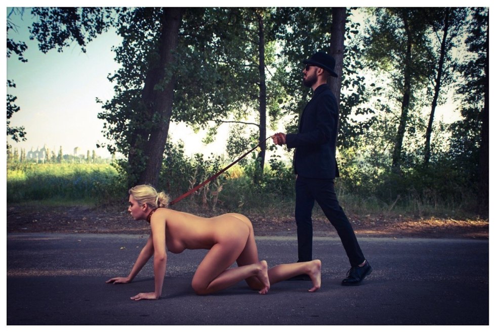 The girl undresses in the parking lot